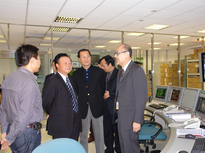 From left: Mr. Kit Szeto leads Mr. Deputy Director Li Shoujin and Mr. Deputy Director General Lin Difu on a tour of Dim Sum TV's broadcast control room. 