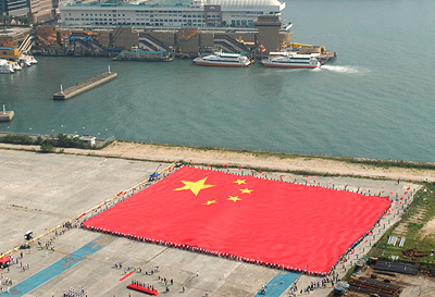 A giant Chinese national flag measuring 89m x 60m and weighing 510 kg was borne aloft by 60 flag-bearers from all walks of life.