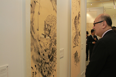 Mr. Kit Szeto admiring the works of the master painters and calligraphers. 